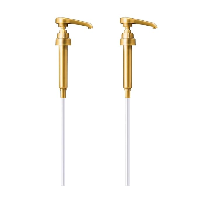 Pair of gold-colored lotion pump dispensers with long white tubes on white background