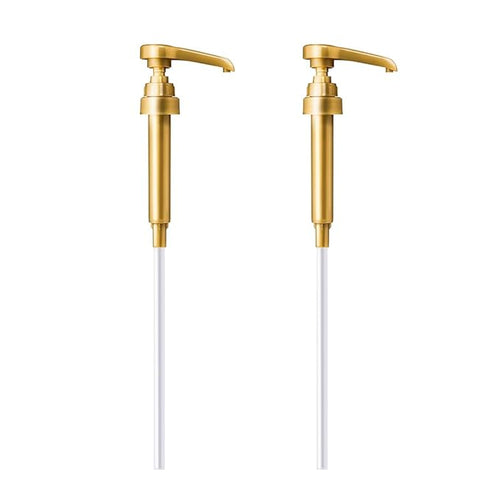 Two gold-colored liquid soap dispenser pumps with long white tubes on a white background