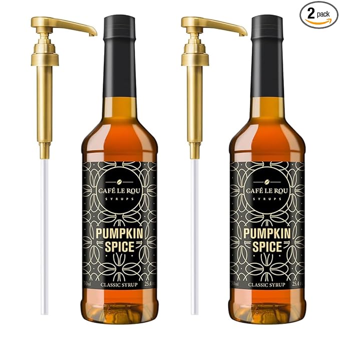 Two bottles of Café Le Rou Pumpkin Spice classic syrup with gold pumps, 25.4 oz each, white background